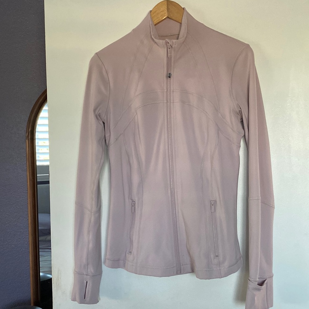 Lululemon define jacket in a very light pink color.
